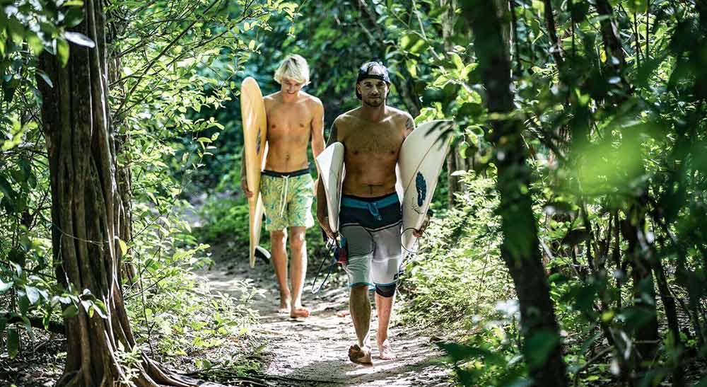 Surfers Walking to Playa Guiones in Costa Rica